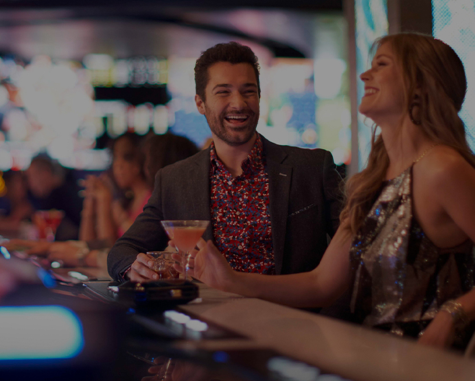 Couple laughing and playing video poker